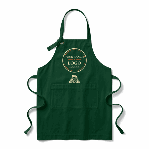 Sample co-branded Acre & Plate apron in forest green with a placeholder ranch logo on the chest and a small Acre & Plate mark below it